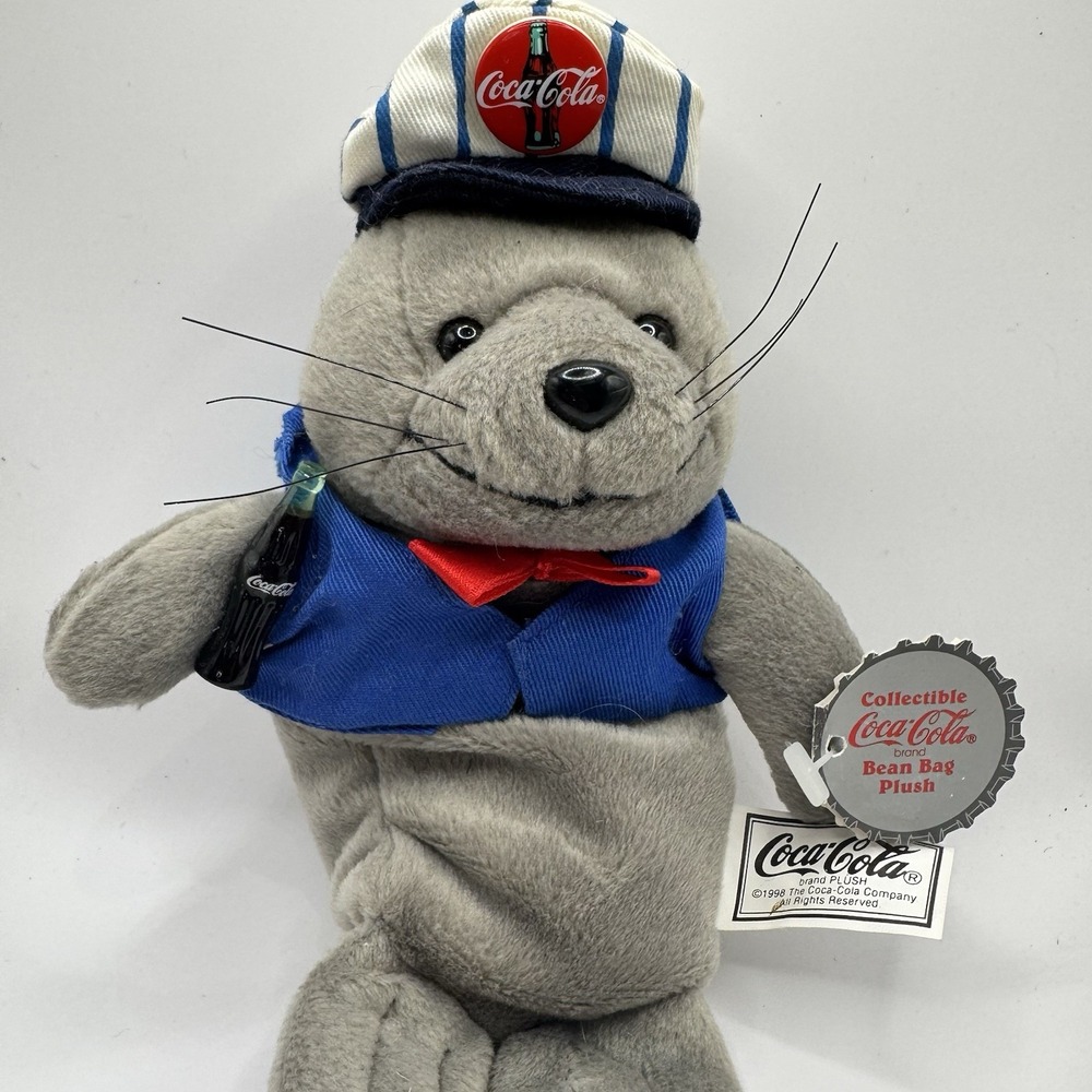 Coca-Cola collectible bean‎ bag plush seal from 1998, wearing a delivery outfit